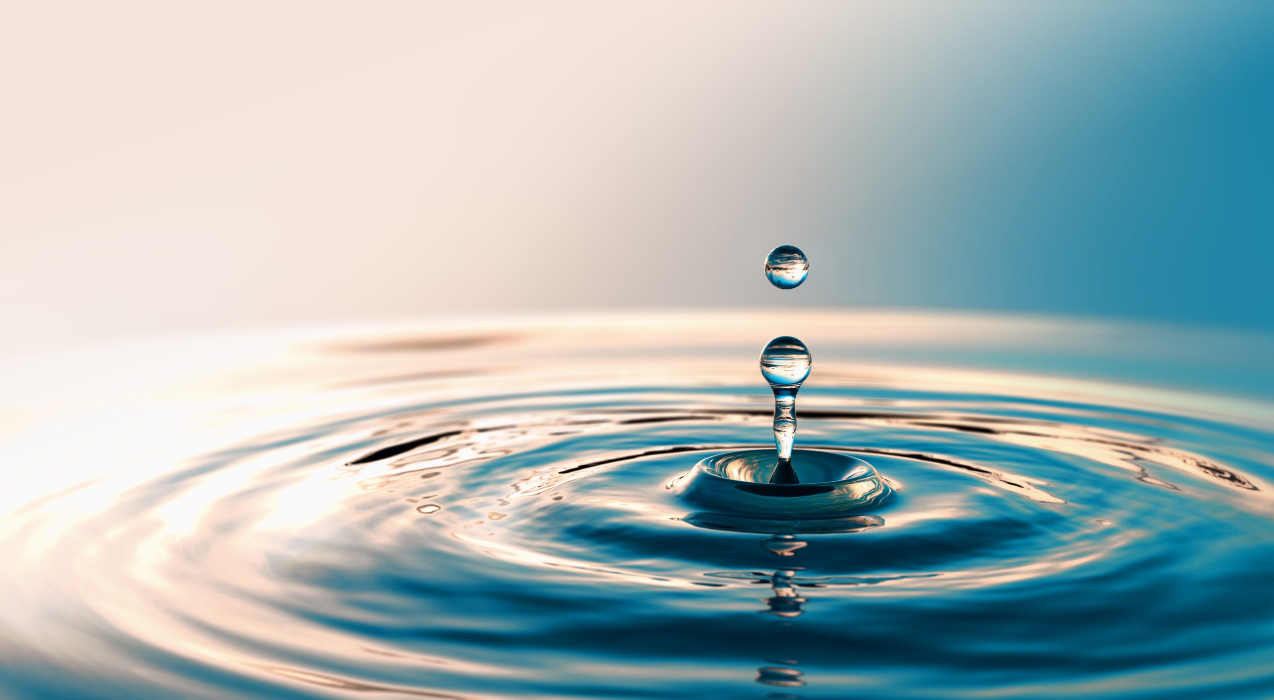 A drop of water working together with a blue background.